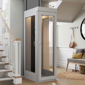 A modern home elevator lift installed next to a staircase in a residential interior. In low cost.