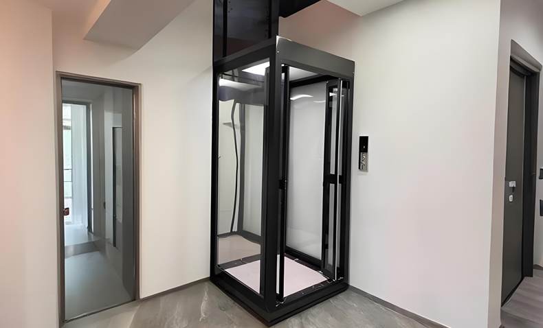 A black mini home lift installed in a modern house