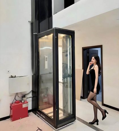 a black elevator for home use with a lady stand nearby.