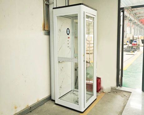A modern mini home lift installed on the corner of the room.