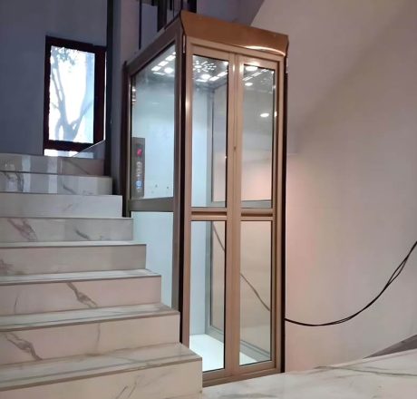 a golden attic lift elevator installed beside a stair