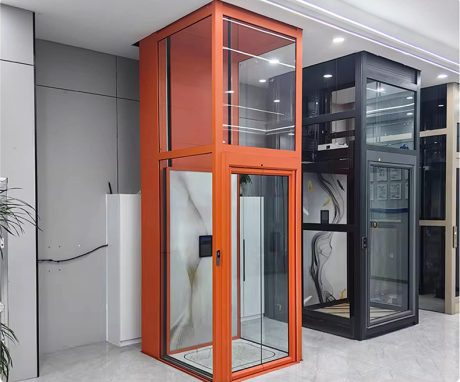 Residential lift featuring a transparent glass design with an orange frame, showcasing its structure.
