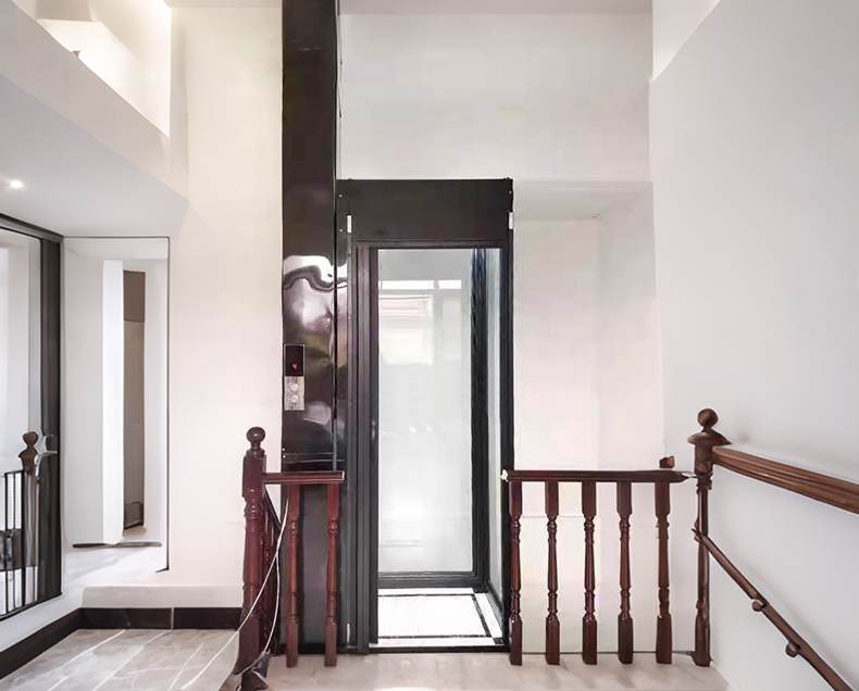 a black home elevator installed beside a wooden handrail
