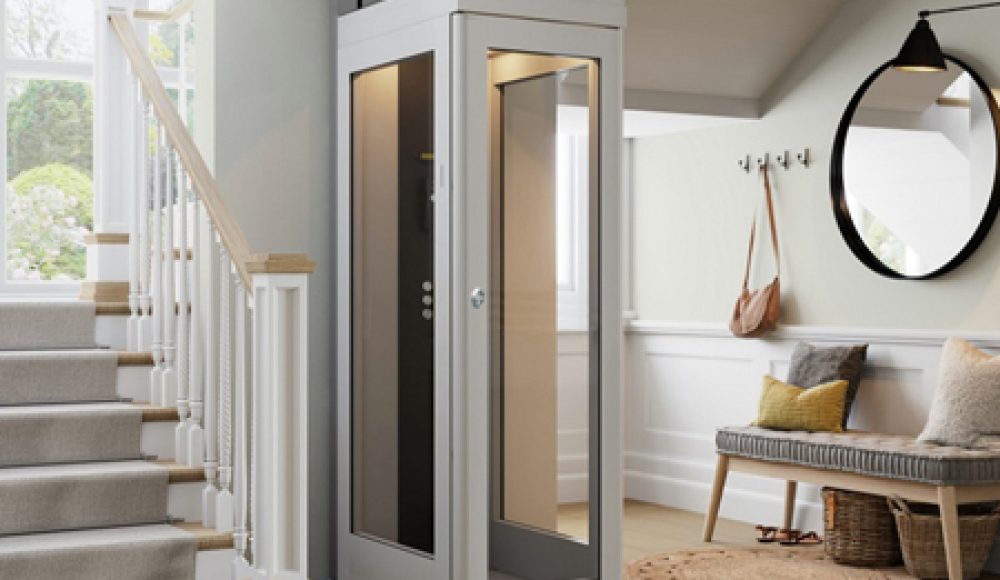 A modern home elevator lift installed next to a staircase in a residential interior. In low cost.