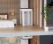 Shaftless home elevator installed in a modern home interior with a bedroom visible.